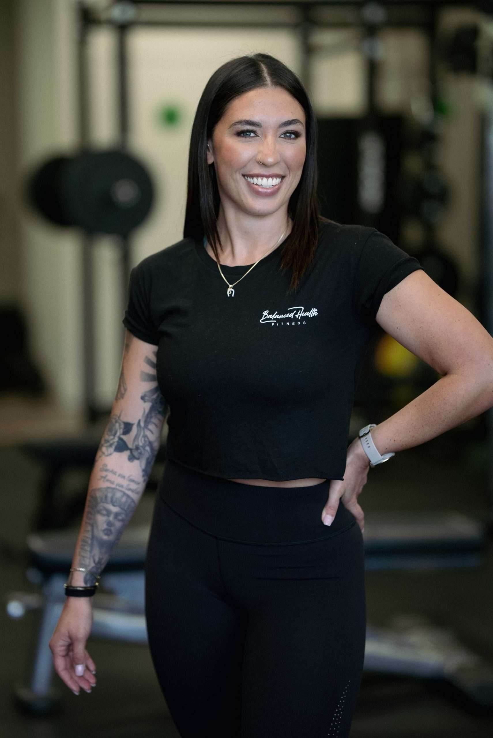 Bridgette Hartz, owner and head coach of Balanced Health Fitness and its online coach, smiling in the Seaford, NY studio.
