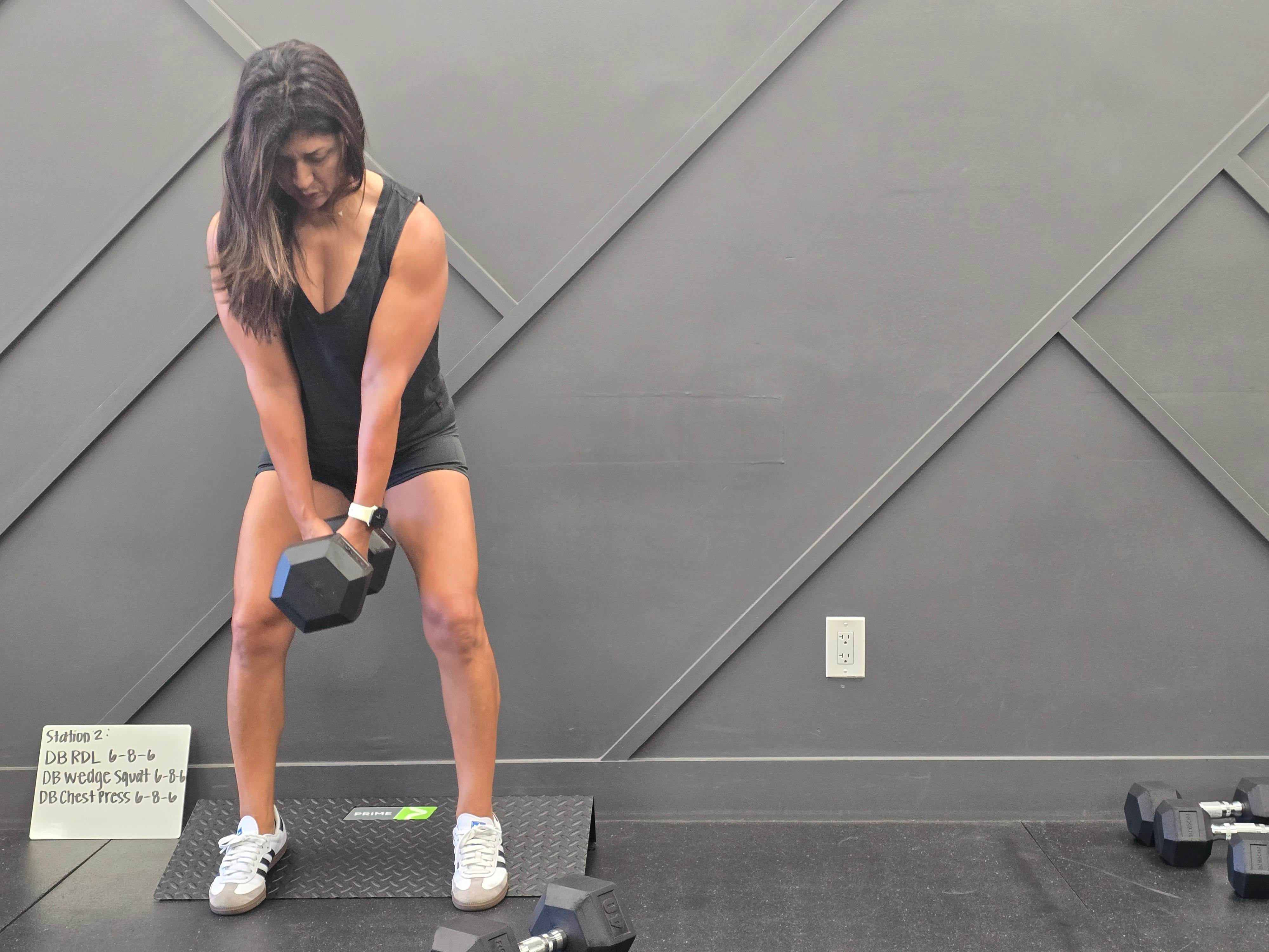 A client doing a dumbbell deadlift at Balanced Health Fitness in Seaford, NY.